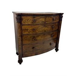 Early Victorian mahogany bow front chest, two short over three long graduating cockbeaded drawers, flanked by faceted columns with carved acanthus leaf capitals, standing on turned bun supports with fluted detailing