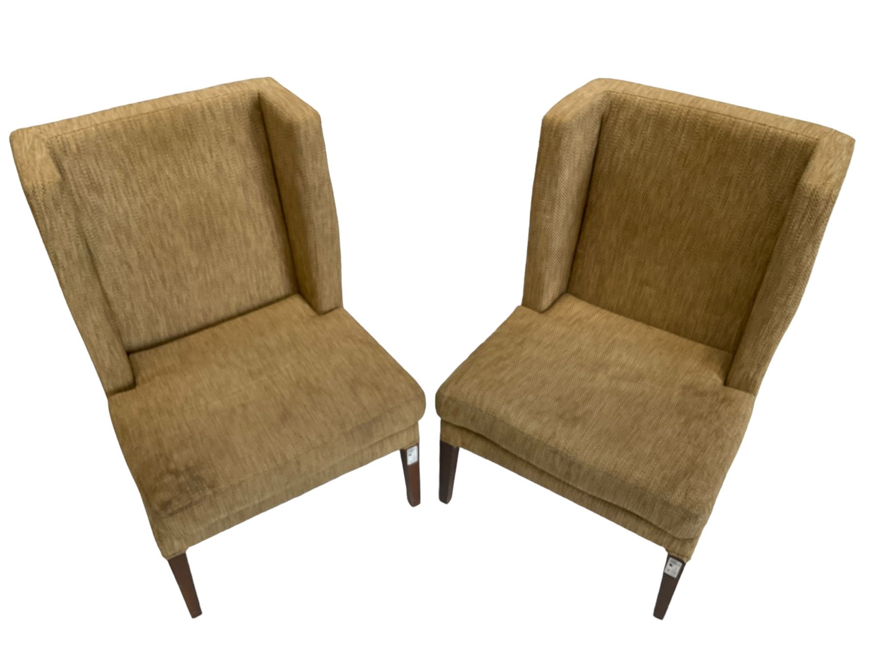 Two wing back armchairs, upholstered in oatmeal fabric