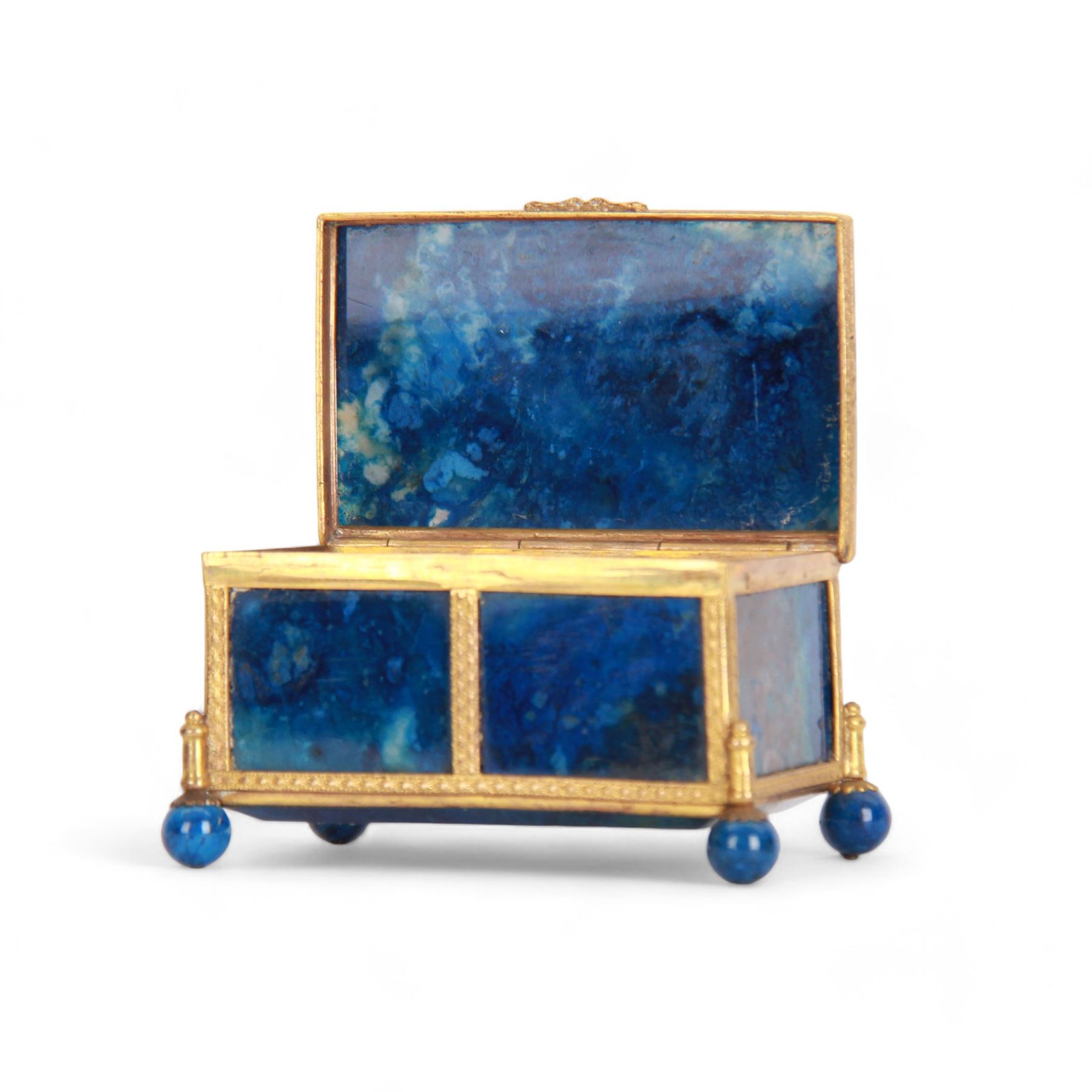 Small 19th century lapis lazuli casket, of rectangular form with gilt metal mounts, and bevel edged hinged cover, raised upon four lapis lazuli ball feet, H4cm L7.5cm D5cm