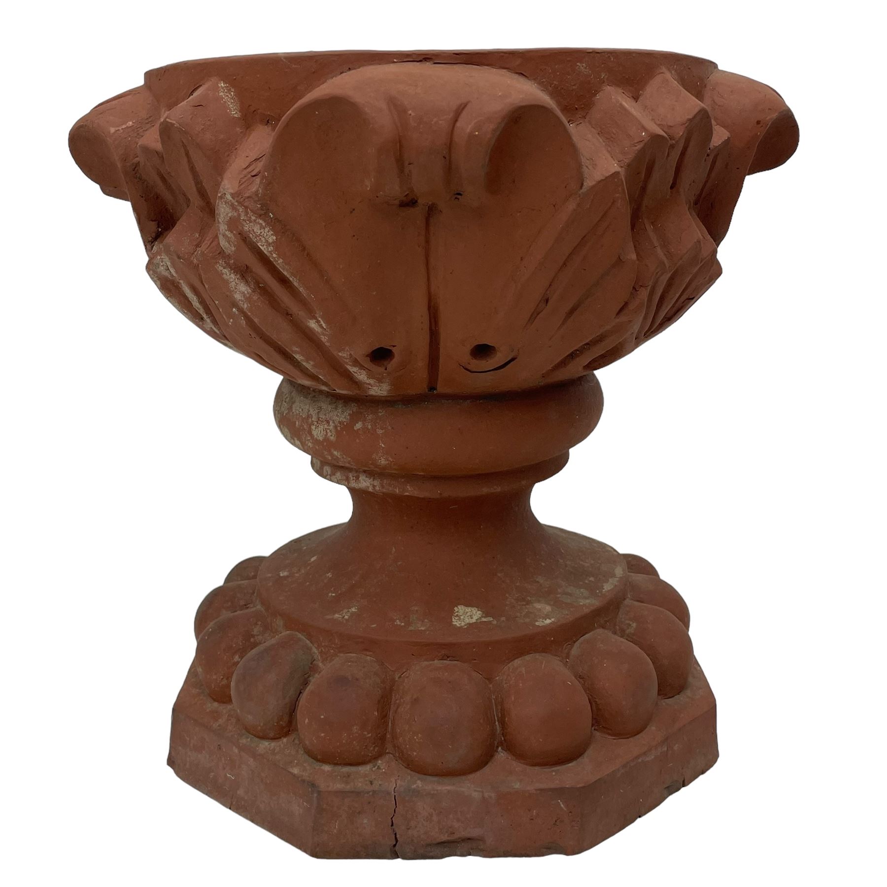 Pair of late 19th to early 20th century red terracotta garden urn planters, the shallow bowls moulded with curled acanthus leaf decoration, on circular foot with globular beaded moulding, octagonal base