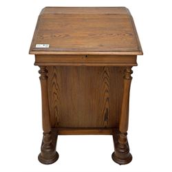 19th century pitch pine Davenport desk, sloping hinged top, fitted with four drawers, on turned column supports, turned compressed feet with castors 