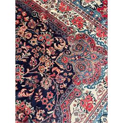 Persian Mahal indigo ground carpet, floral medallion on a field of swirling leafy branches and flower heads, shaped ivory field band decorated with flower head bouquets and trailing branches, the border decorated with floral motifs, within guard stripes