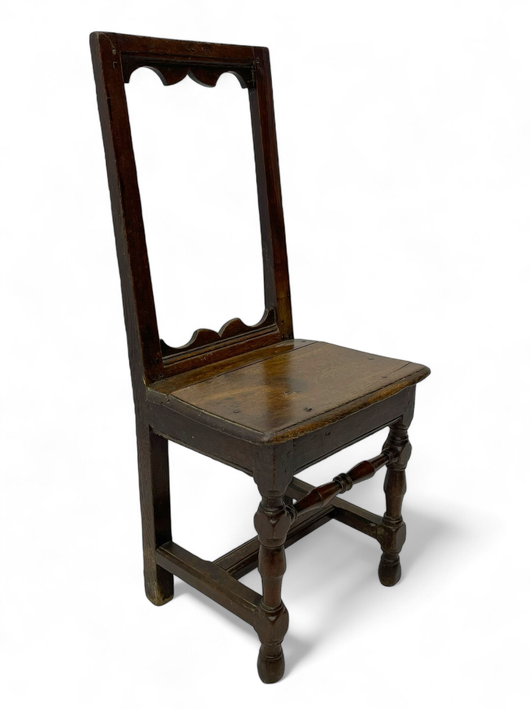 Small late 17th century oak side chair, open frame back with shaped upper and lower brackets, moulded plank seat, on turned supports united by moulded H-shaped stretchers