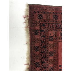  Afghan red ground rug, field decorated with Guls, repeating border, 204cm x 112cm  