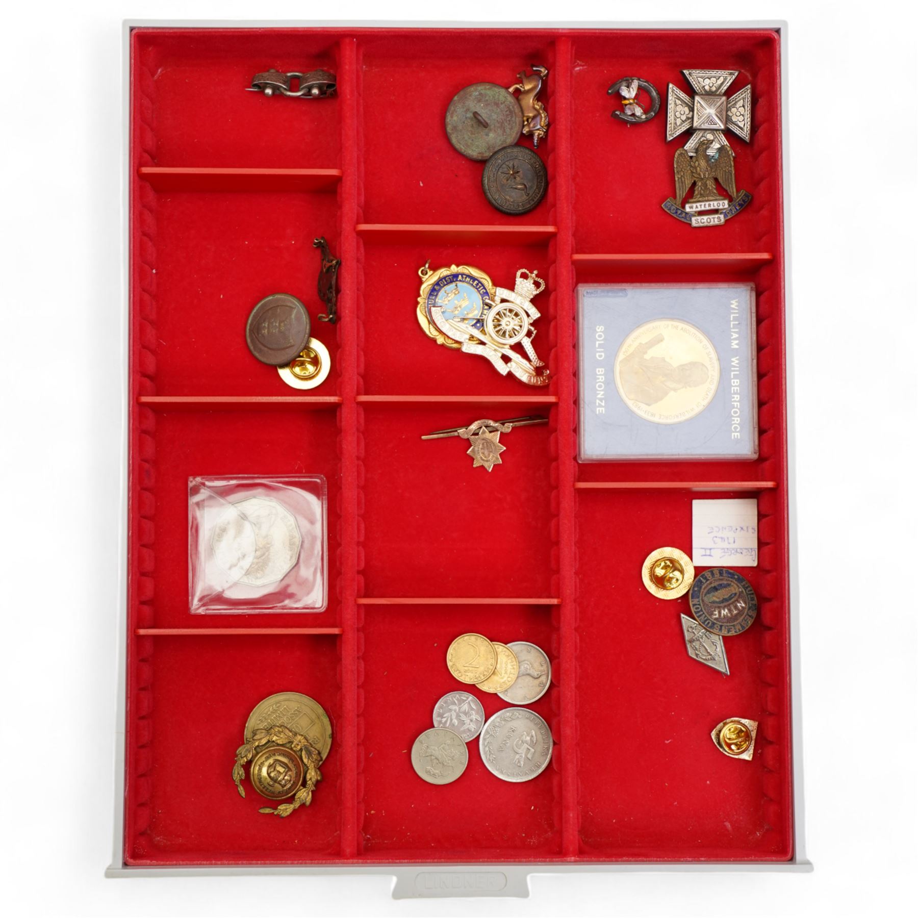 Tokens, medallions and miscellanea, including 'Hedley Swan and Co Ltd Joplings' one penny, 'Blackmores Beverley Road' one shilling, 'Brett's Limited' one shilling, various pin and other badges, buttons, Goldstream Guards bar brooch, small number of coins etc, housed in four Lindner trays