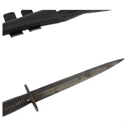 British commando knife, with ribbed ebonised steel hilt with a blued stiletto blade marked, with leather scabbard, blade 18cm