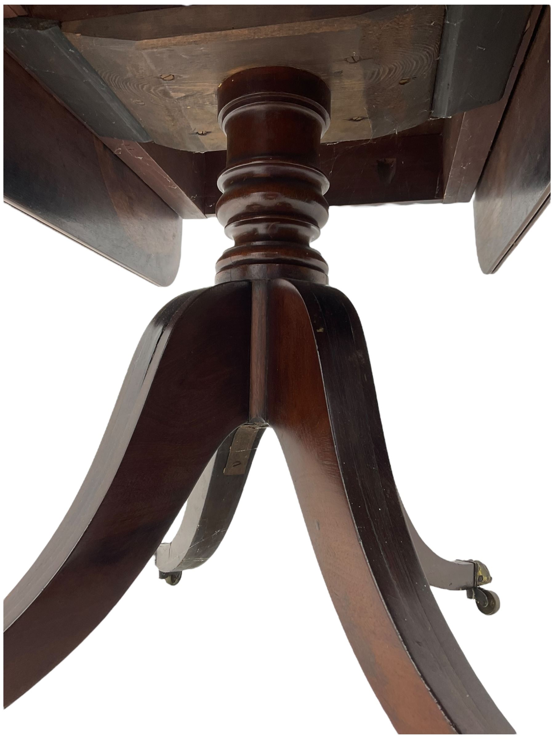 Early 19th century mahogany supper table, rectangular reed moulded drop-leaf top with rounded corners, fitted with single end drawer, on turned pedestal with four out-splayed supports with brass paw castors 