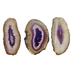 Three purple agate slices, polished with rough edges, of various sizes largest H7cm, L10cm