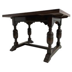 Mid-20th century medium oak dining table, rectangular draw-leaf extending top, quadruple turned pillar supports on sledge feet joined by stretcher