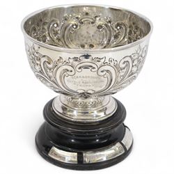 Edwardian silver trophy cup, of circular form, the bowl embossed with floral and foliate d...