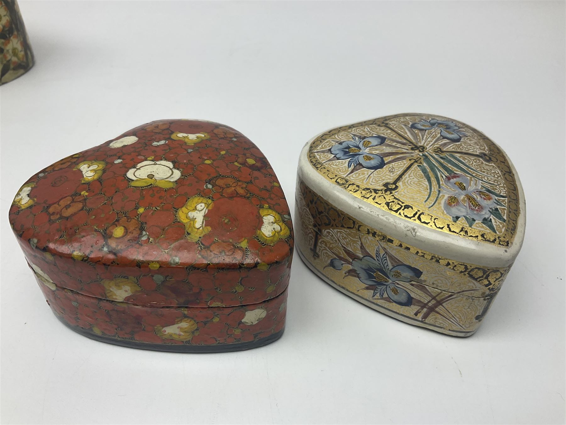 Nine lacquered boxes, including seven heart shaped examples, mainly decorated with floral designs, largest H12cm