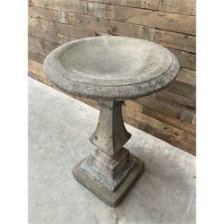 Cast stone garden bird bath, circular dished top, raised on square tapering column, on stepped base with separate mounting plinth