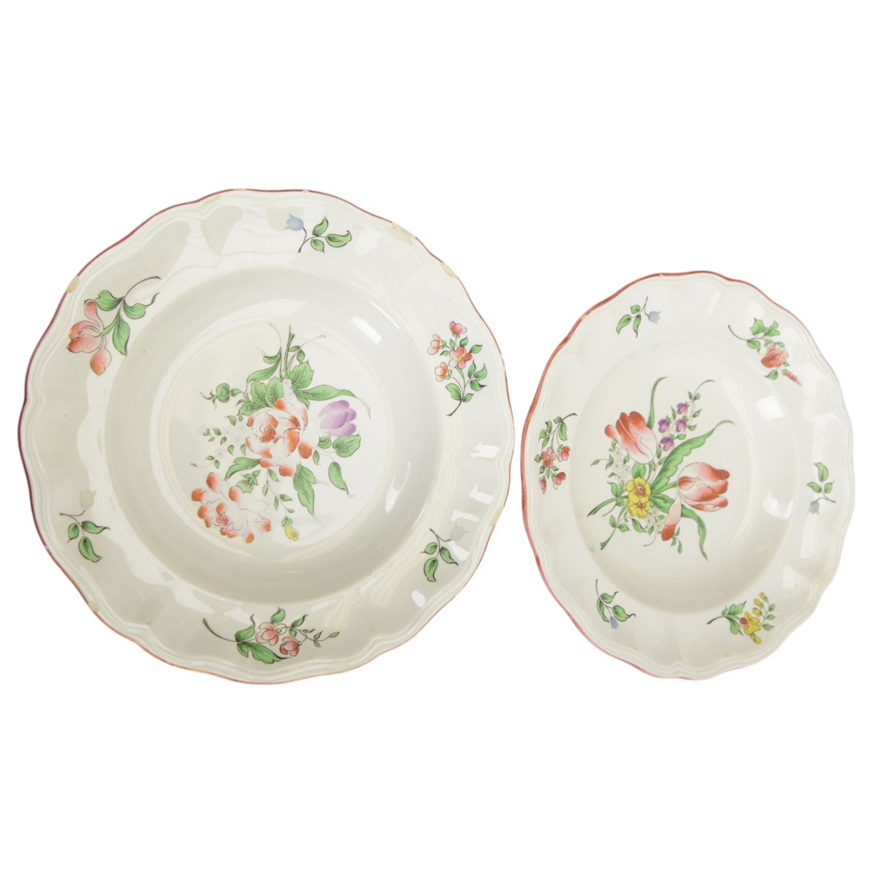 Keller & Guerin Luneville French part tea and dinner service,painted with floral sprays and scattered sprigs within pink edged rims, including covered dish, two meat platters, three coffee pots etc 