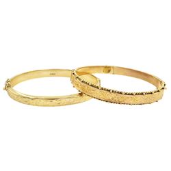 Gold hinged bangle, with engraved floral decoration, Birmingham 1972 and one other gold bangle, both hallmarked 9ct