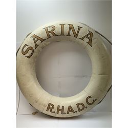 Four mid 20th century yacht lifebuoys, each painted in gold and black lettering 'Sarina R.H.A.D.C', upon a white ground, D68cm