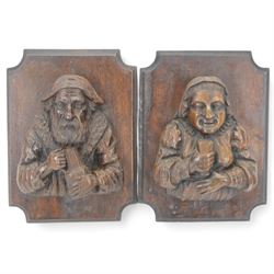 Pair of carved oak figures, modelled as a man and woman in traditional dress, each holding...