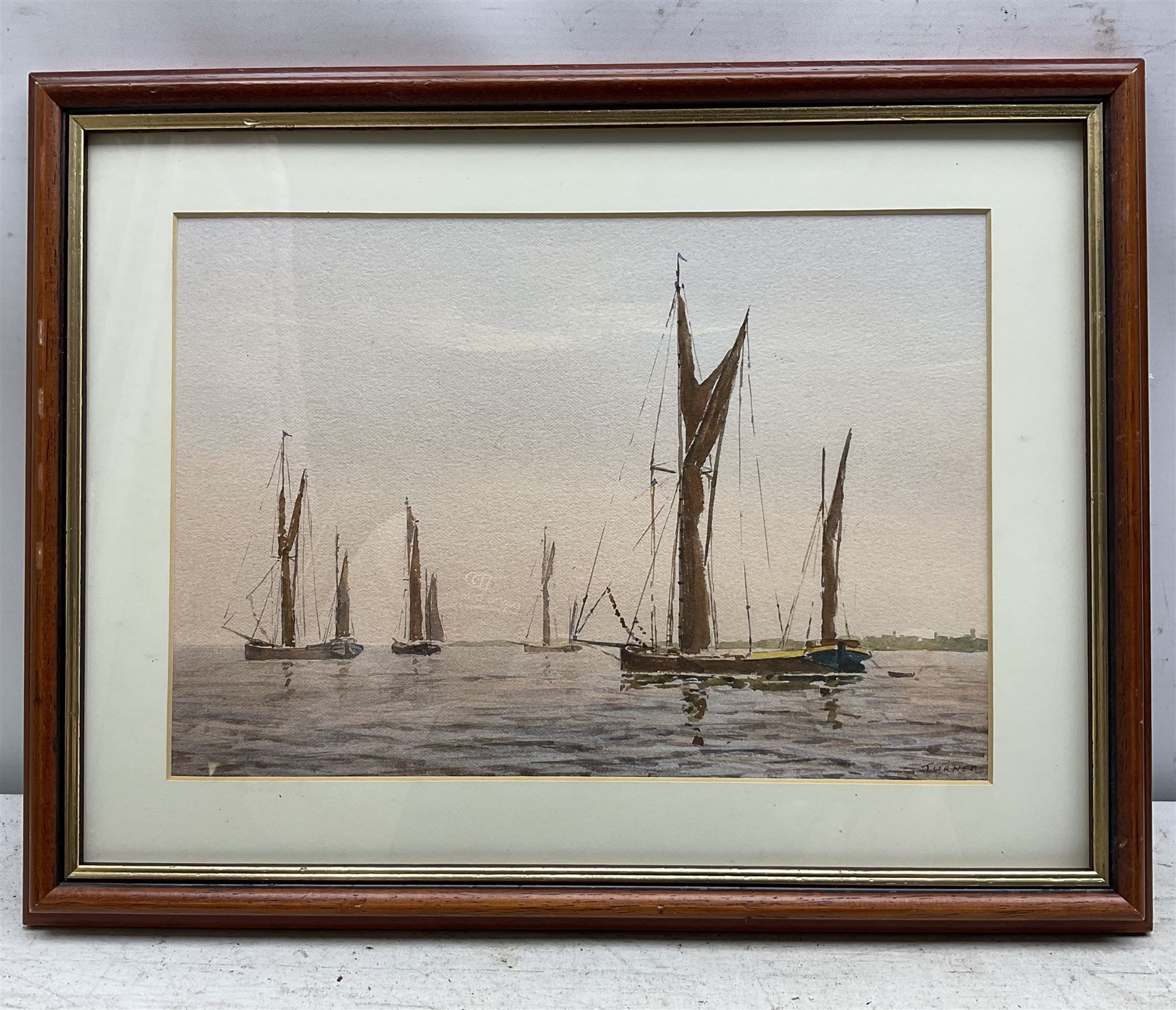 F Preston (British 20th Century): 'Staithes - The Beck', watercolour signed, titled and dated 1977 verso 17cm x 37cm; Roy Williams (British 20th Century): 'Robin Hood's Bay', charcoal signed and dated '92, 21cm x 30cm; together with a watercolour of barges signed 'Turner' (3)