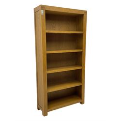 Light oak open bookcase fitted with four shelves 