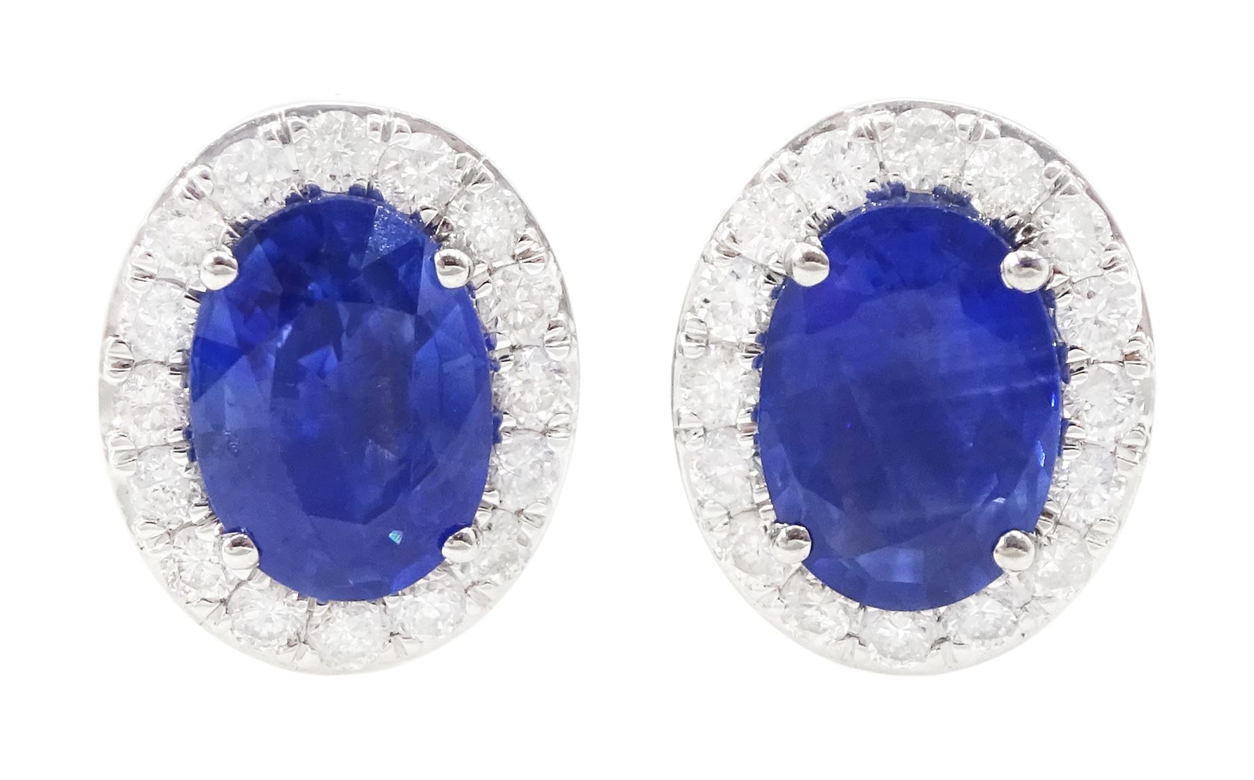 Pair of 18ct white gold oval cut sapphire and round brilliant cut diamond cluster stud earrings, hallmarked, total sapphire weight approx 2.05 carat