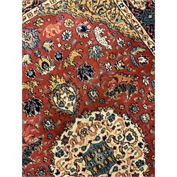 Persian design red ground rug, decorated with plant and animal motifs, the border decorated with floral design panels with guards