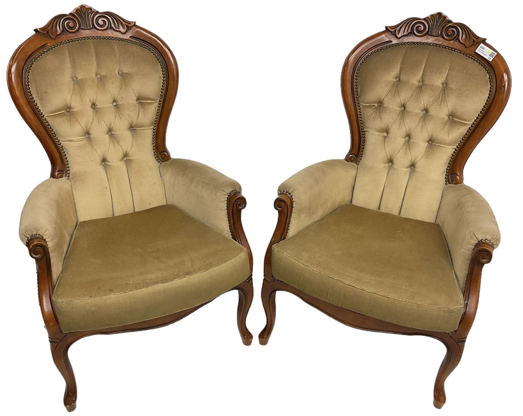 Pair of Victorian design stained beech armchairs, scroll and scallop carved cresting rail, upholstered in buttoned champagne fabric, on cabriole supports