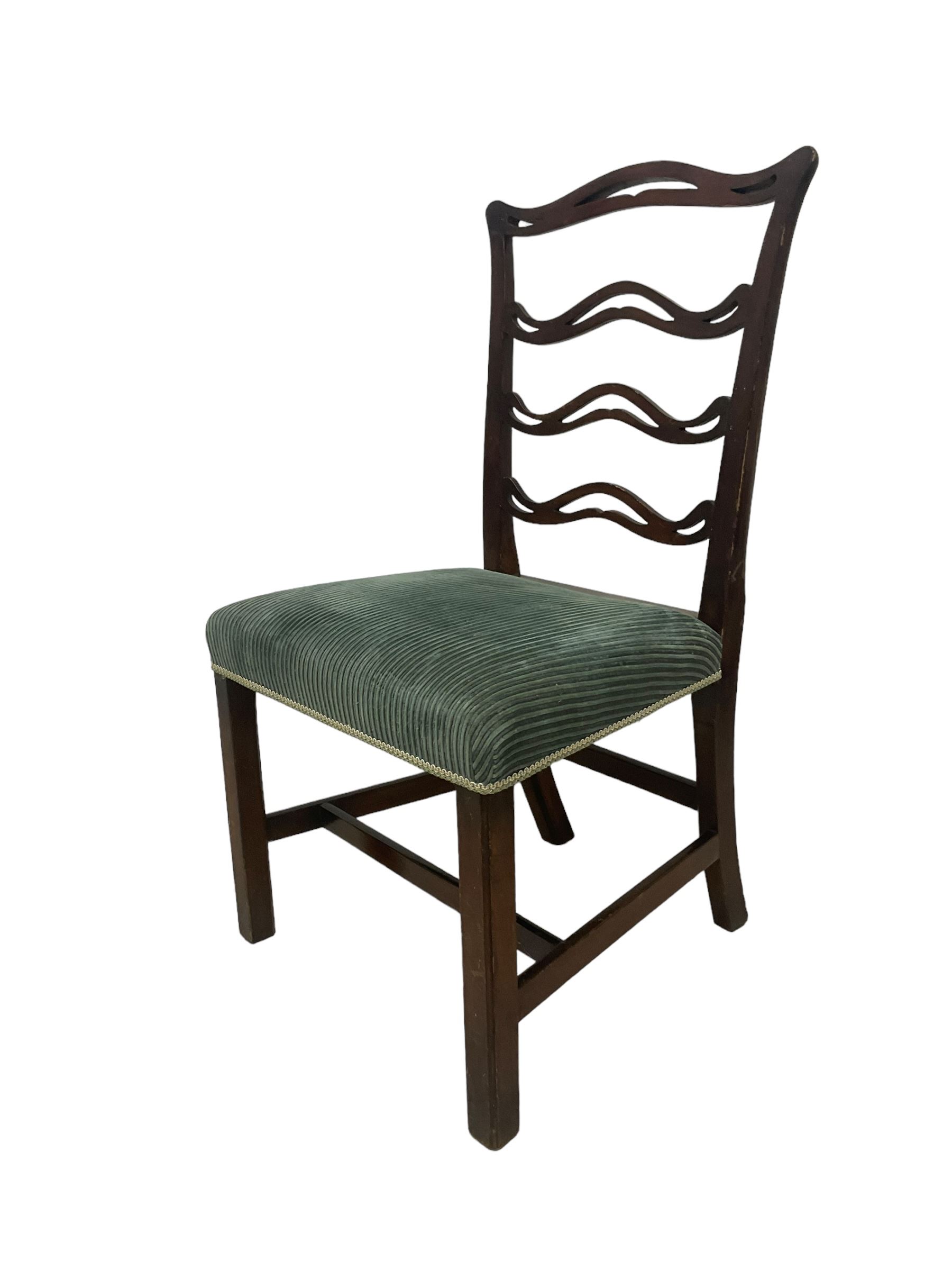 Set of twelve (10+2) Chippendale revival stained beech dining chairs, pierced waived ladder backs with over-stuffed over seats, on square moulded supports joined by stretchers