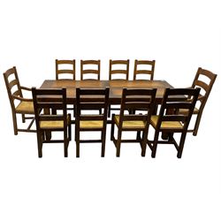 Antix Furniture - oak extending refectory dining table, rectangular plank top with two additional leaves and two drawers to the longer side, on square supports connected by H-stretcher; set of ten (8+2) ladder back dining chairs with rush seats