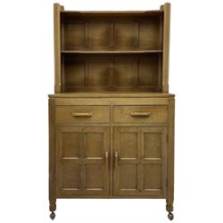 Yorkshire Oak - oak dresser, raised two heights plate rack over two drawers and double cupboard, enclosed by two panelled doors, panelled sides and back, on octagonal feet with castors 