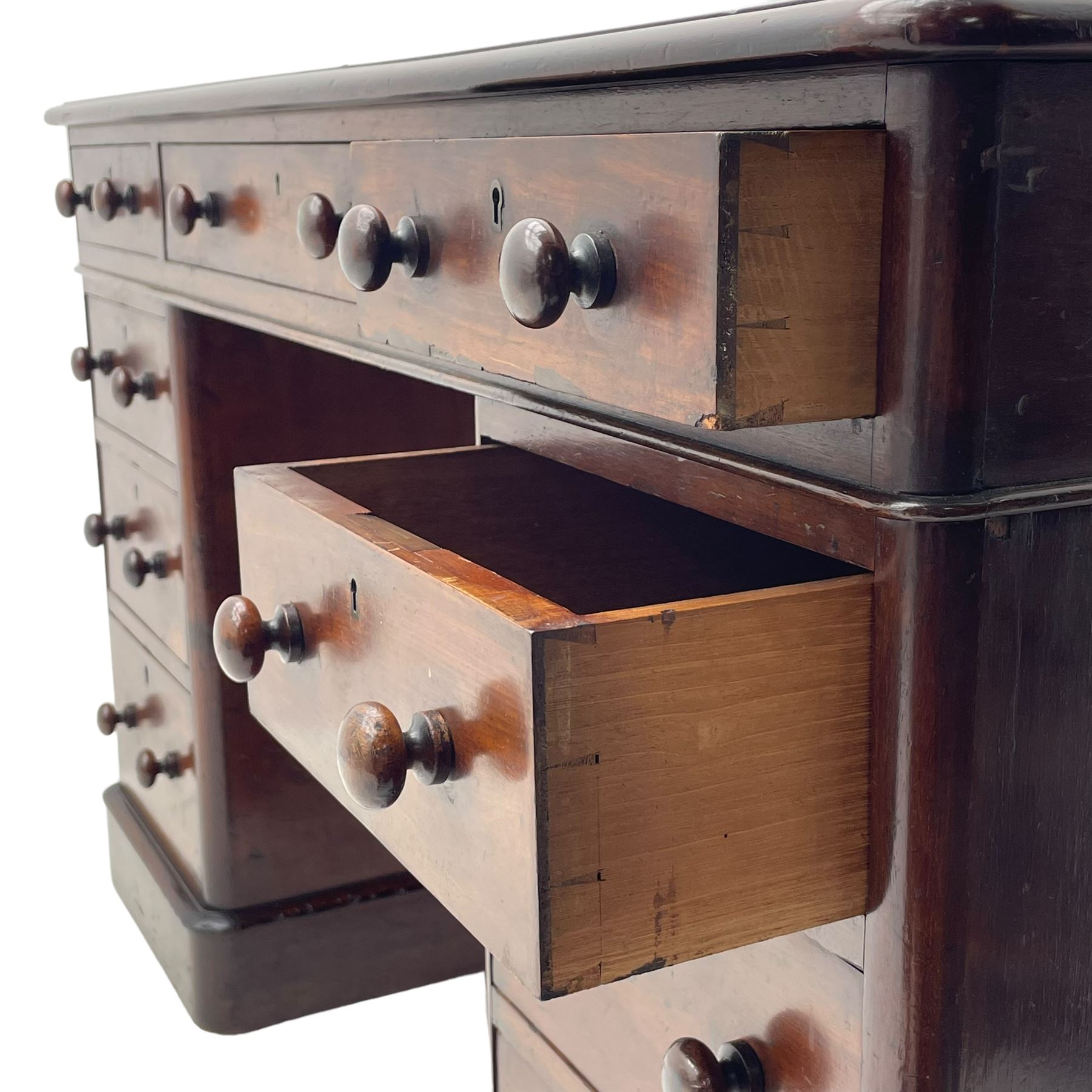 Victorian mahogany twin pedestal desk, moulded rectangular top with inset leather writing surface, nine drawers each fitted with two turned handles, on moulded plinth base 