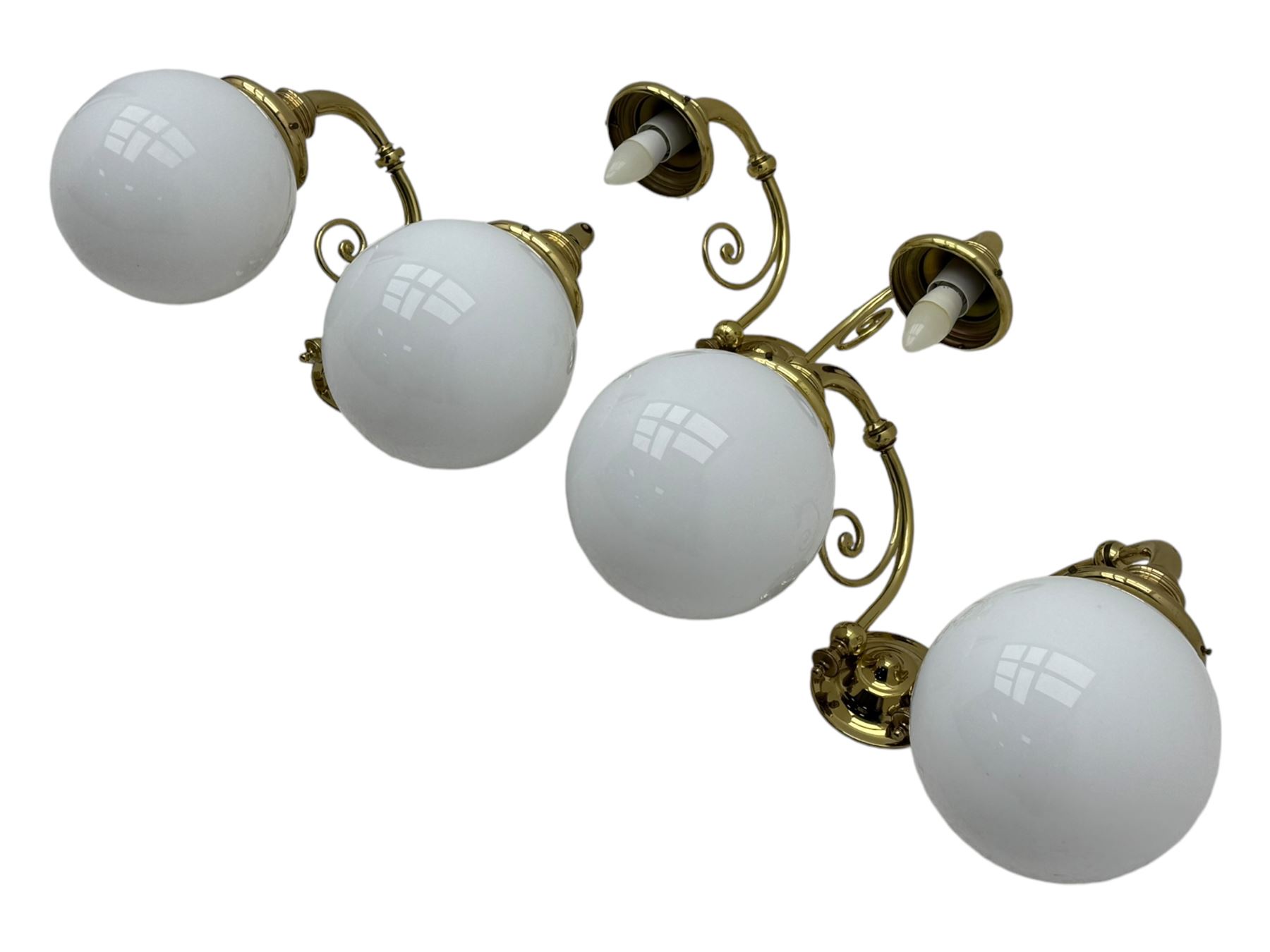 Two brass double-arm wall mounted lights, each with frosted glass globes and scrolled arms (W50cm, D26cm, H31cm); matching central double-arm light with candle-style fittings (W42cm, D24cm, H22cm)