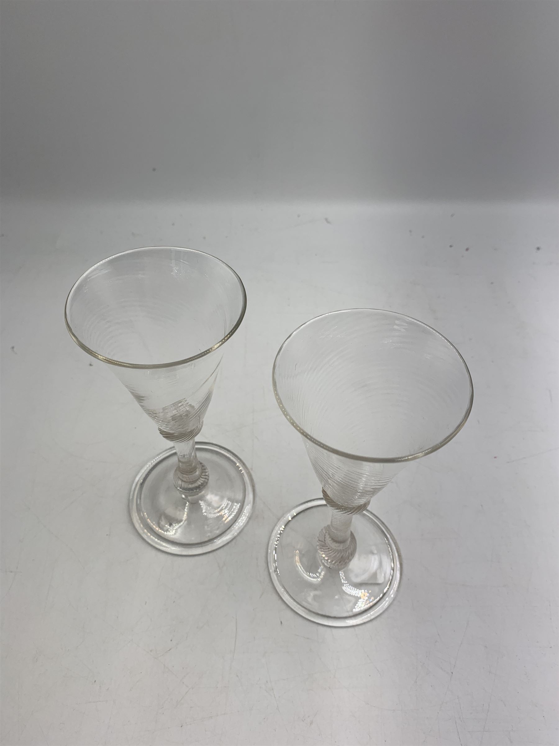 Pair of 18th century Liege wine glasses, circa 1730, with wrythen fluted trumpet bowls and knopped stems, H14.5cm