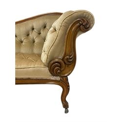 19th century walnut framed chaise longue, shaped back over scrolled arms decorated with moulded curling acanthus carvings, upholstered in deep buttoned champagne fabric, raised on cabriole supports with applied floral carved decoration, on castors