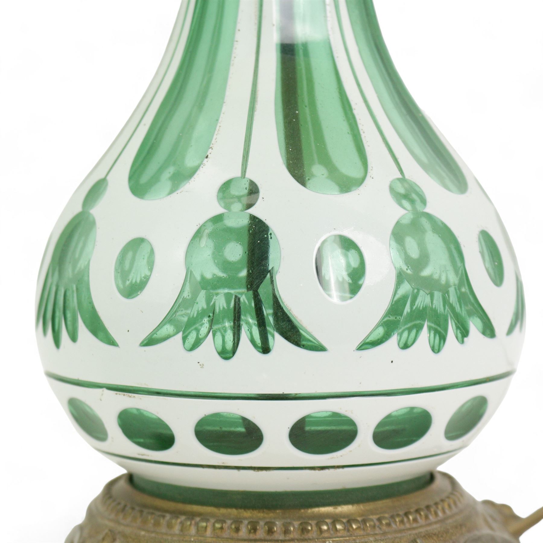 Early 20th century Bohemian green and white glass overlaid table lamp, of bulbous form with tapering neck, decorated with flower heads, with associated butterscotch mushroom form glass shade with wavy rim, on a cast brass base with four lion paw supports, H53cm