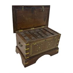 20th century mahogany chest, rectangular hinged top enclosing removable compartments with carved starburst motifs with linear and geometric patterns, brass inlay to the top and front, mounted corners and edges, on bracket base