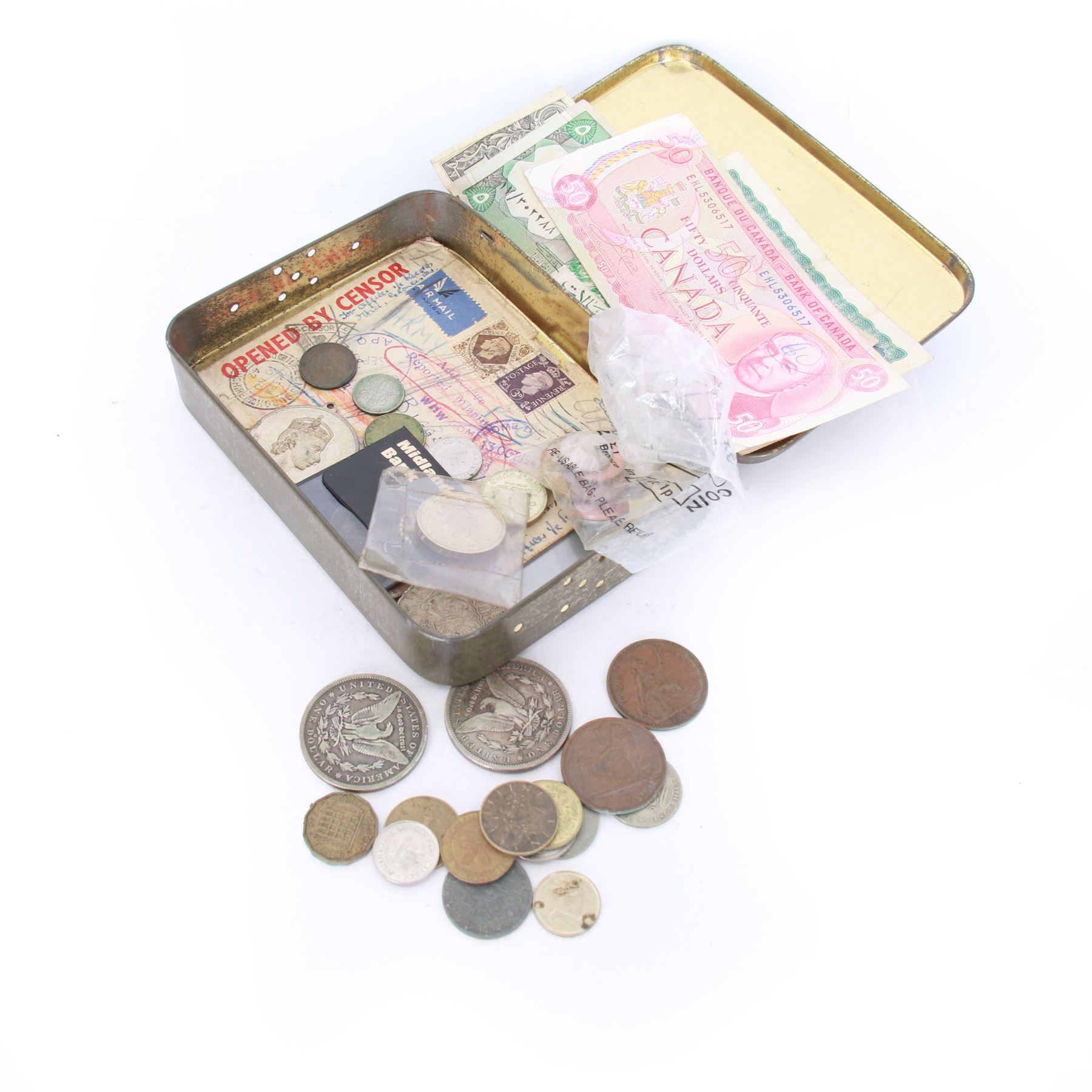 Various coins and banknotes including two Morgan dollars, in a vintage tin