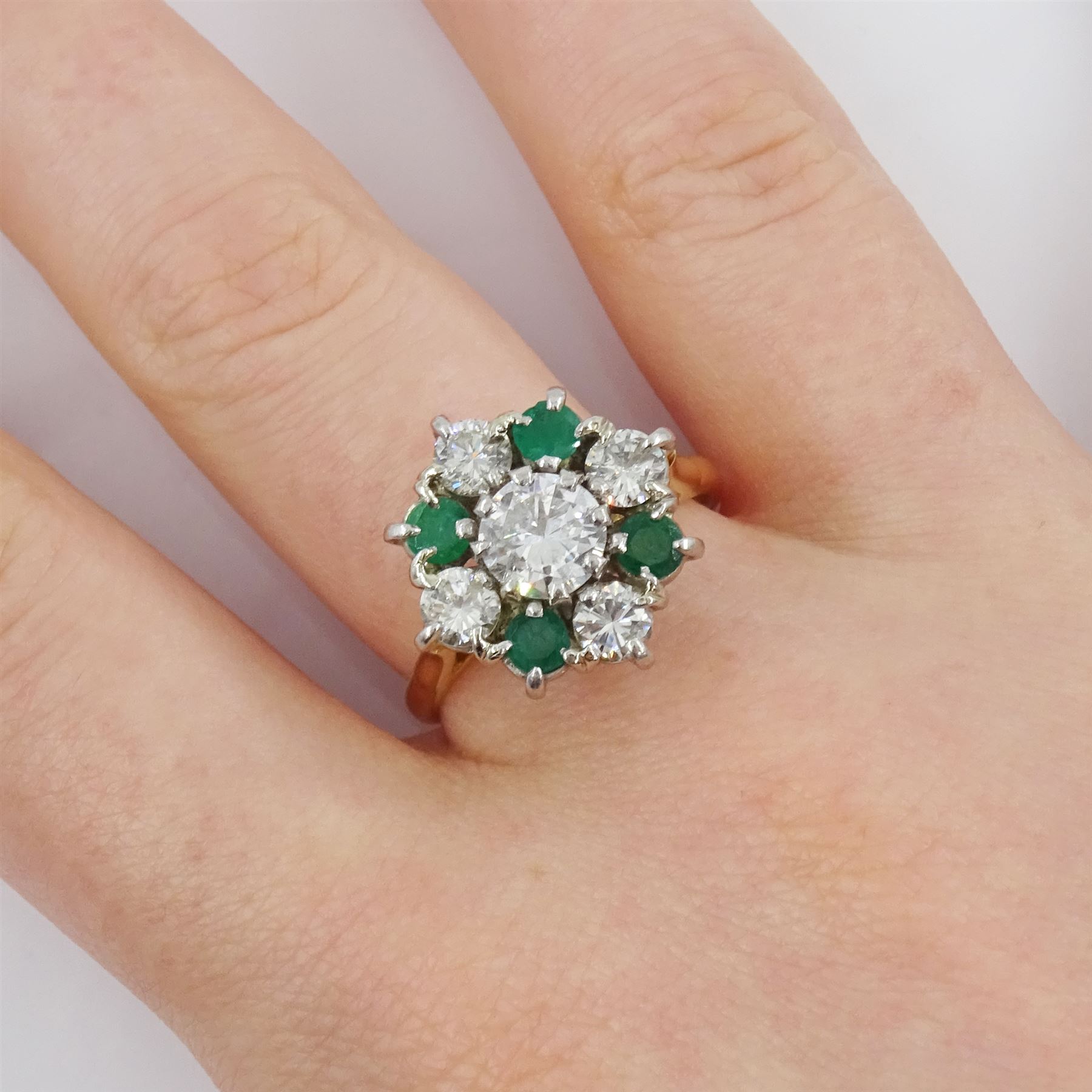 18ct gold emerald and diamond cluster ring, the central round brilliant cut diamond of approx 0.80 carat, with four stone round cut emerald and four stone round brilliant cut diamond surround, Sheffield 1977, total diamond weight approx 1.70 carat