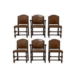 Set of six (4+2) early 20th century oak dining chairs, arched back and seat upholstered in tan leather with studwork detail, on turned supports united by bobbin-turned stretchers