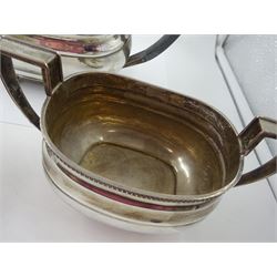 1930s silver three piece tea service, comprising teapot, open sucrier and milk jug, each of oval form with oblique gadrooned rim, the teapot with Bakelite handle and finial, hallmarked James Dixon & Sons Ltd, Sheffield 1932