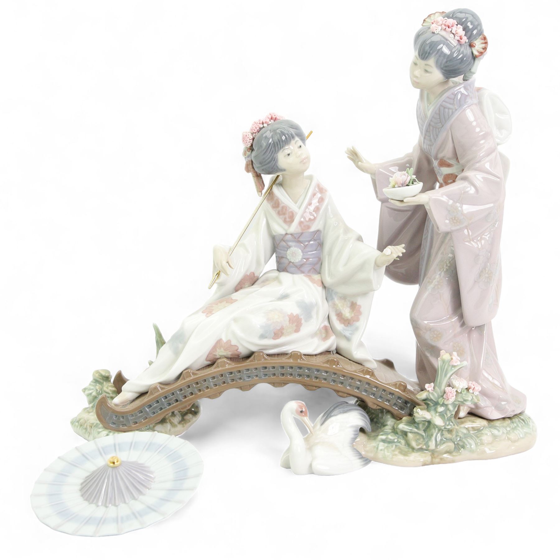 Lladro figure group, 'Springtime In Japan', modelled as two Geisha on a bridge with a crane, sculpted by Salvador Debonno, no 1445 H30cm