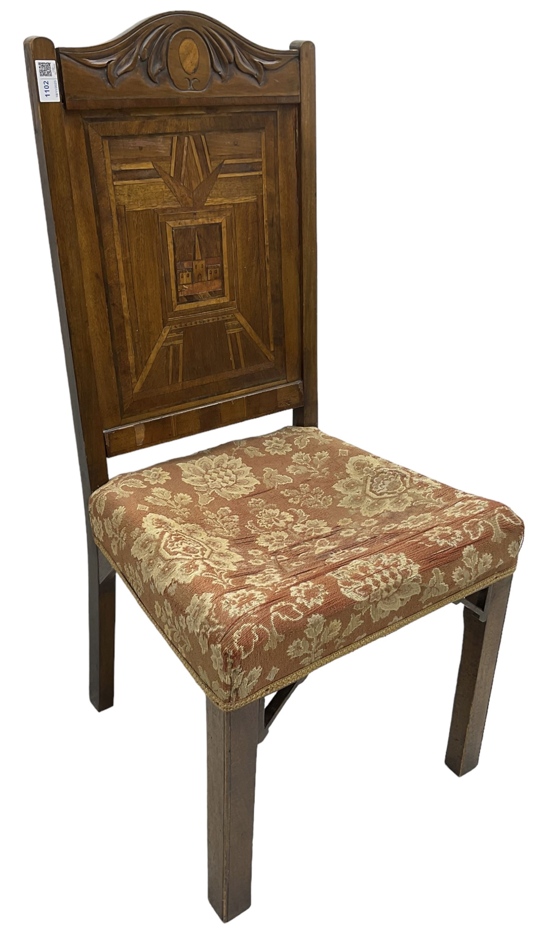 19th century walnut side chair, foliage carved cresting rail over geometric inlaid back with central panel depicting buildings, upholstered seat, on moulded and chamfered square supports