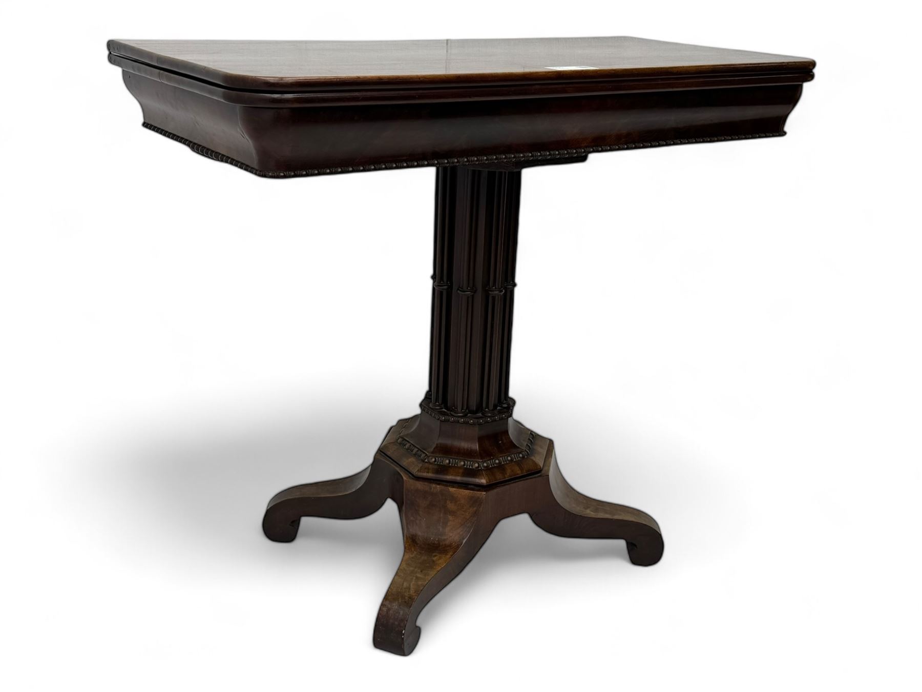 Victorian mahogany tea table, rectangular fold-over and swivel action top with rounded corners, ogee moulded frieze with applied bead, octagonal column mounted by cluster column uprights, on step moulded octagonal foot with applied beading, splayed and scrolled feet with recessed castors 