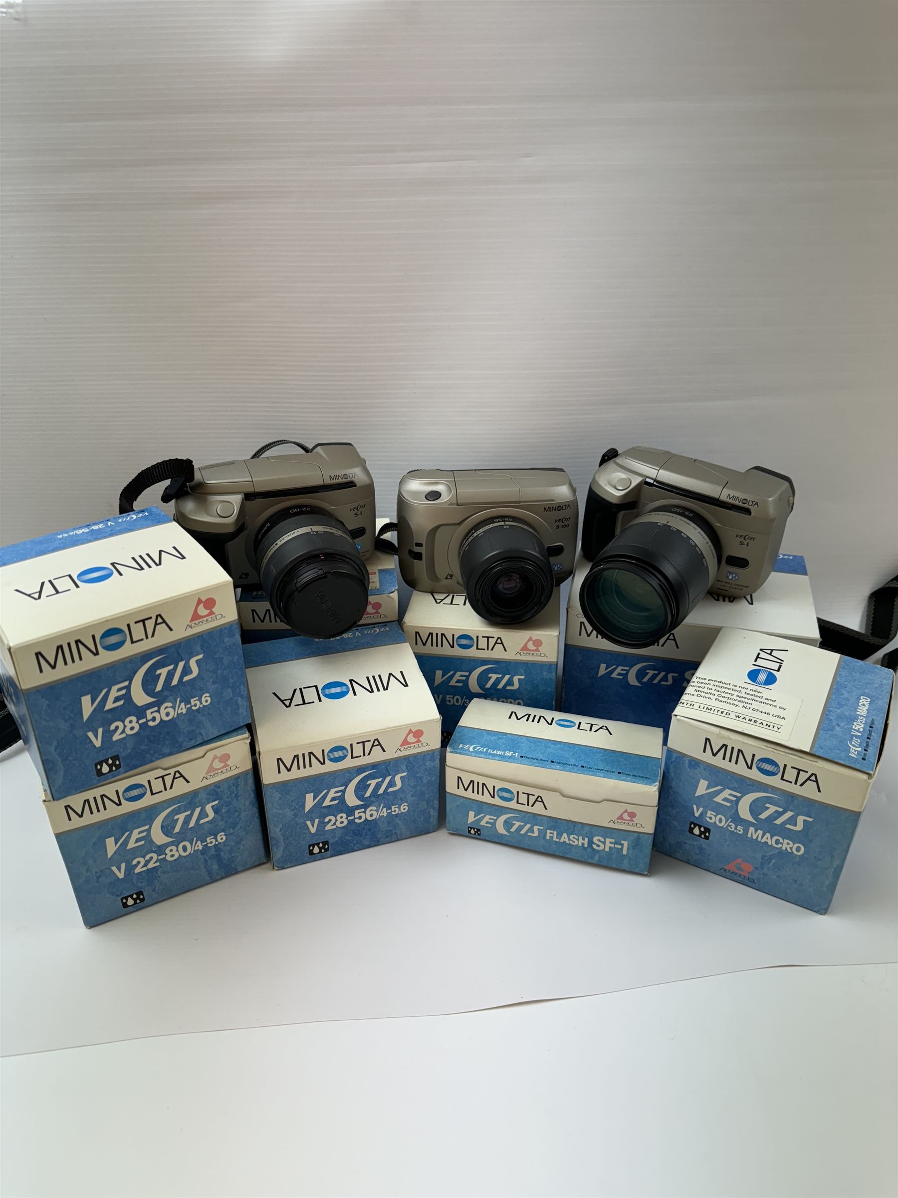 Four Minolta Vectis cameras bodies, to include two Vectis S-1 examples, serial nos. 96622420 & 02629088 and two Vectis S-100 examples, serial nos. 98713950 & 98704095, together with a collection of Minolta Vectis accessories and lenses, including boxed examples