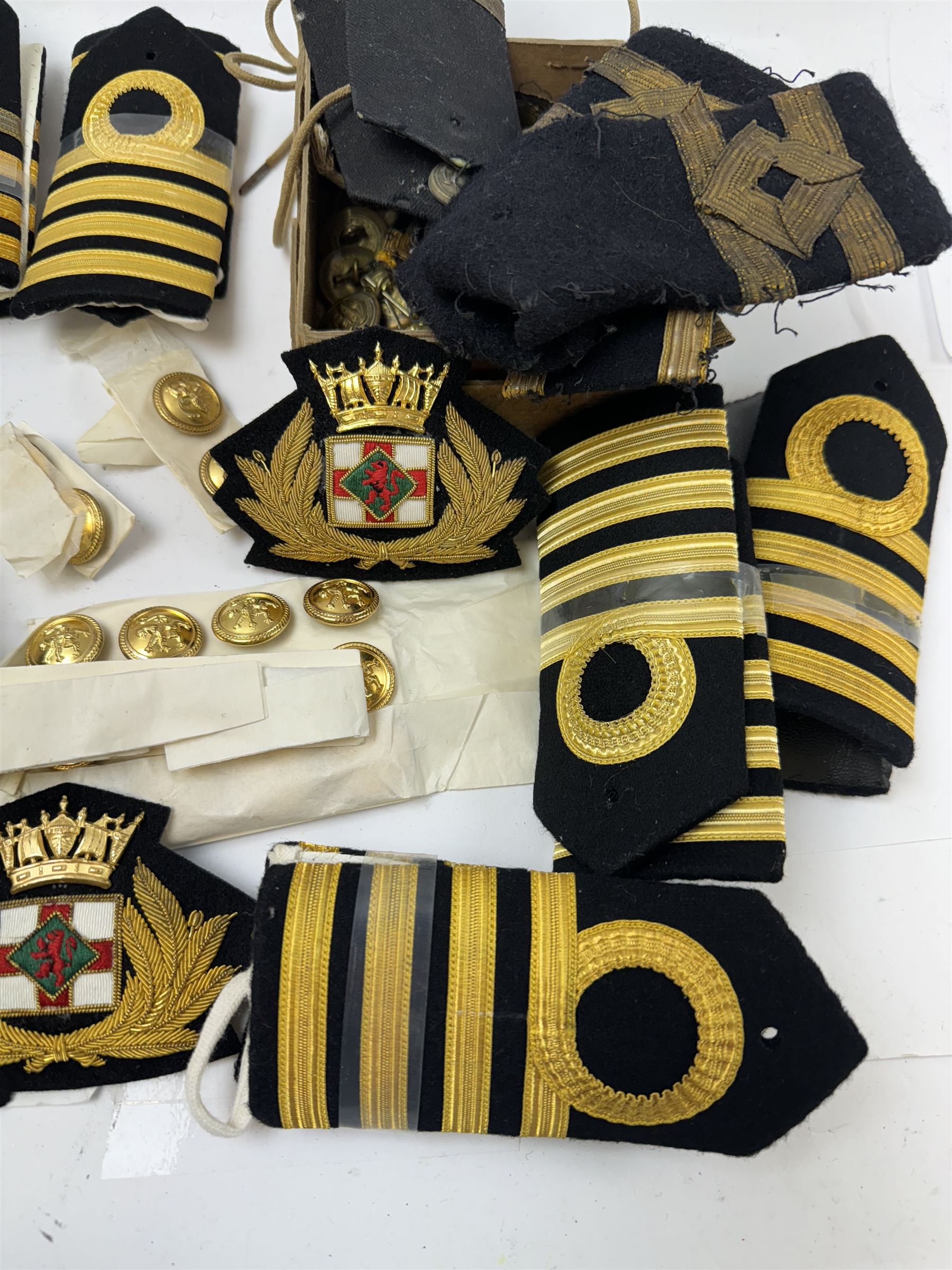 Royal Navy Lieutenant's Frock Coat by Haycock and Jarman, together with other naval accessories, including four pairs of Captain's insignia, six pairs of Captain's shoulder boards, a Merchant Navy cap badge and a collection of other badges, buttons and shoulder boards 