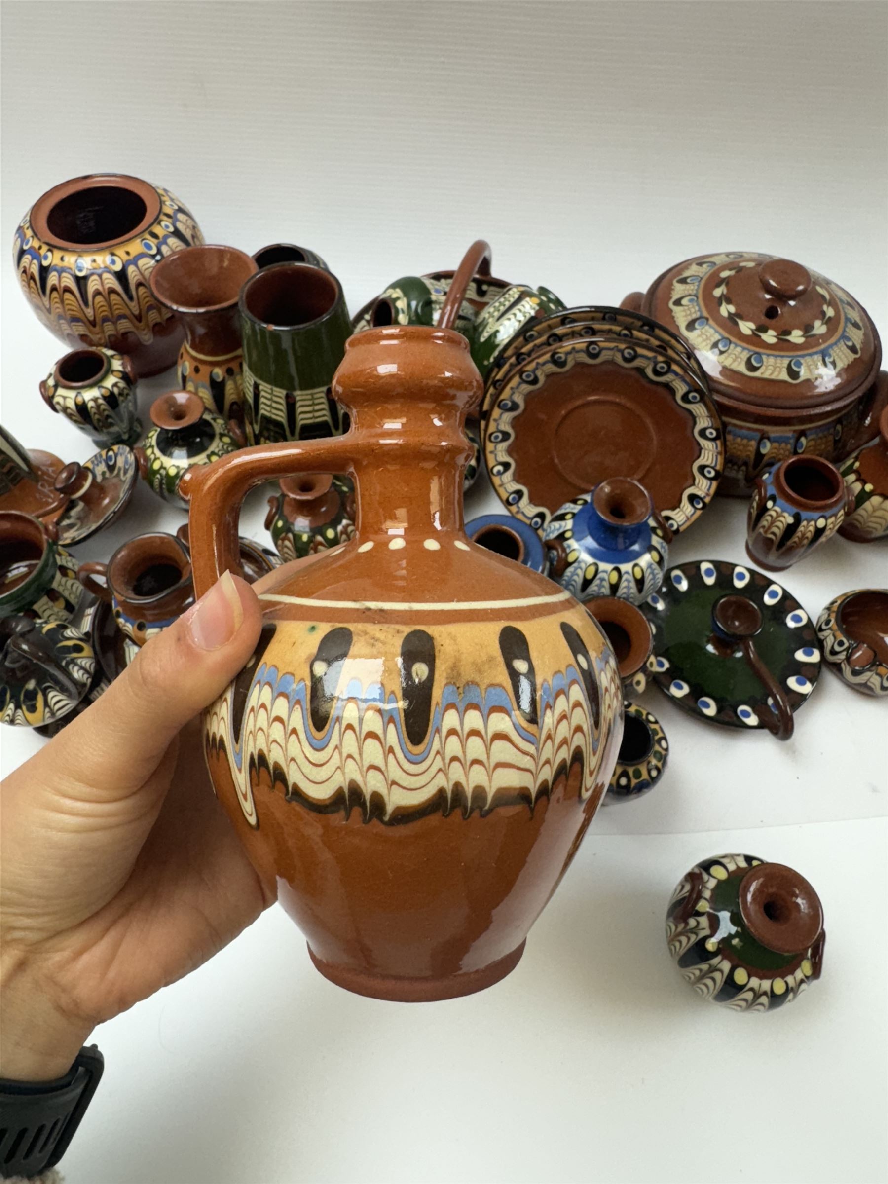 Collection of slipware, including miniature vases, baskets, candlesticks jugs etc 