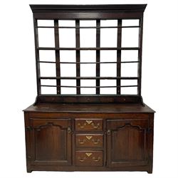 18th century oak dresser, projecting cornice over three heights plate rack with three small drawers, rectangular ovolo-moulded top over three central drawers and two flanking cupboards, enclosed by fielded panelled doors, on stile supports 