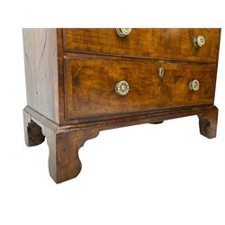 George I walnut chest, moulded rectangular top with book-matched veneers within crossbanding, fitted with two short over four long graduating drawers, moulded drawer fronts with brass handles, on bracket feet, the chest will split into two sections 