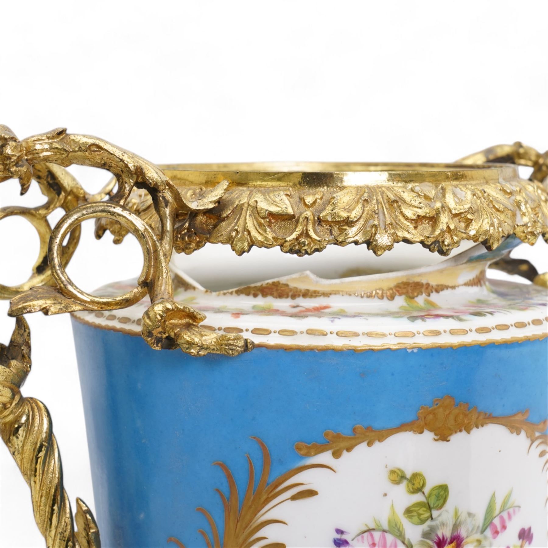 Pair of 19th century Sevres pattern porcelain and ormolu six light candelabra, each with branches cast as lilies, carnations etc, the two handled vase shaped base with oval panels painted with cherubs amongst flowers on a bleu de ciel surround and raised on an ormolu foliate stem and circular base with scrolling bracket feet H76cm (2)  