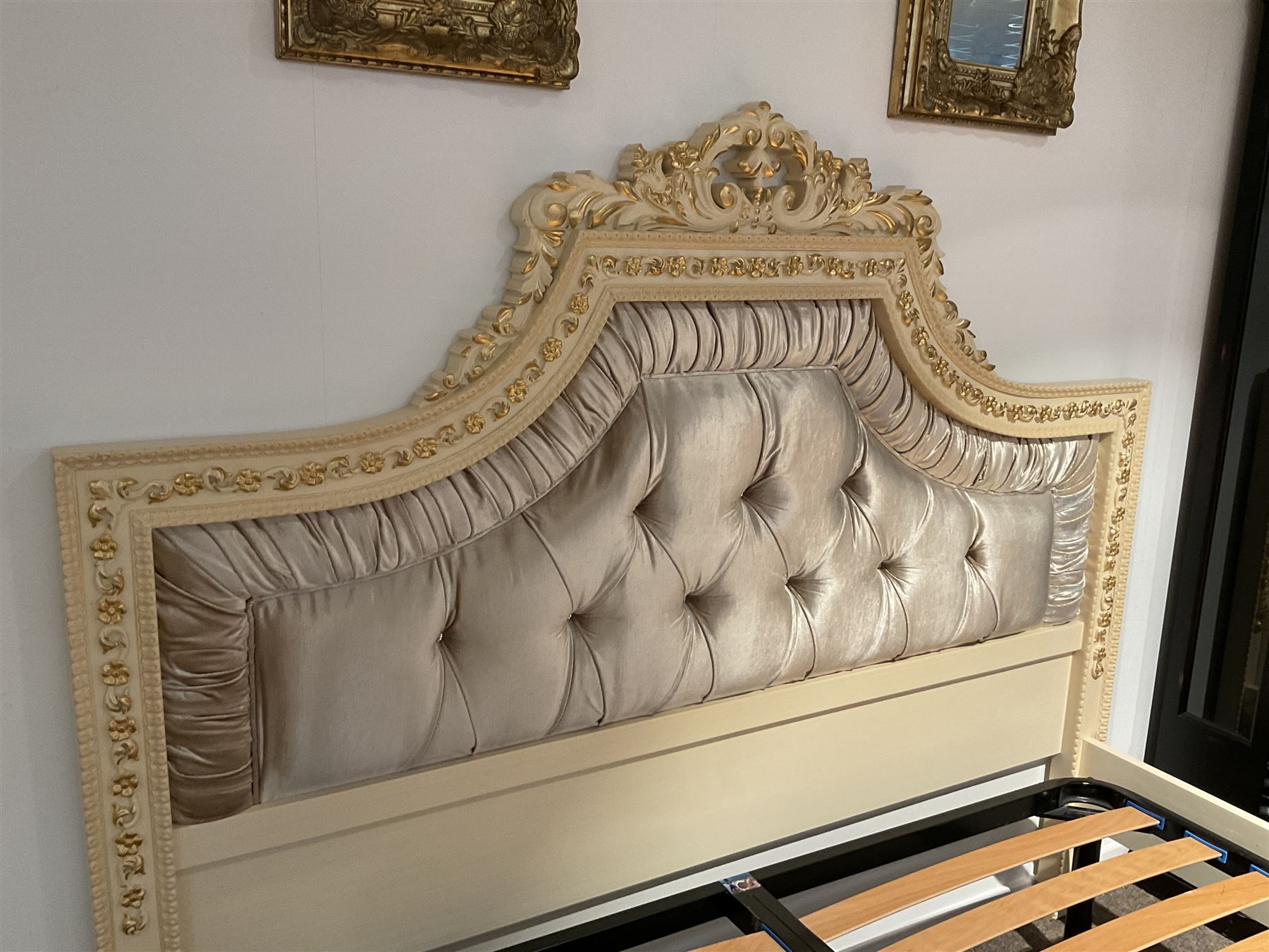 Barnini Oseo - super king 6' 'Reggenza' bedstead, the headboard with a pierced cartouche pediment with extending scrolling foliage, decorated with trailing gilt flower heads, upholstered in buttoned lilac velvet, raised on cabriole feet, in a cream finish