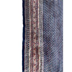 Large North-West Persian Arrak indigo ground carpet, the field decorated all-over with small Boteh motifs, multiple band border decorated with repeating geometric designs