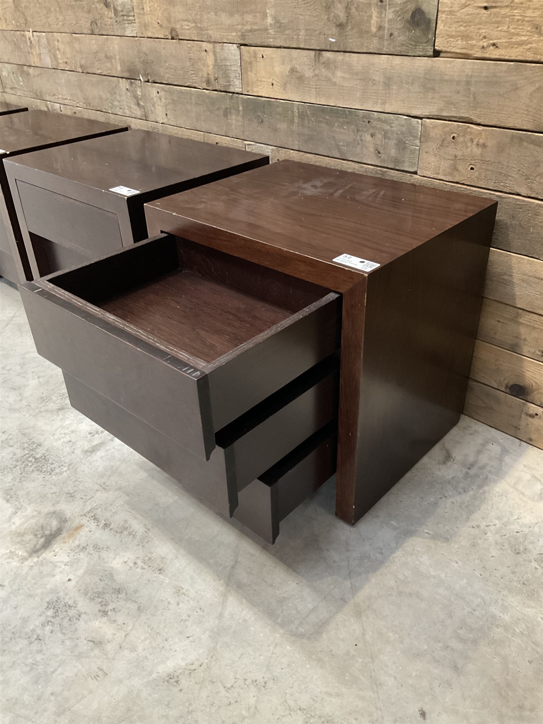 Four rosewood bedside chests, fitted with three stepped soft-close drawers